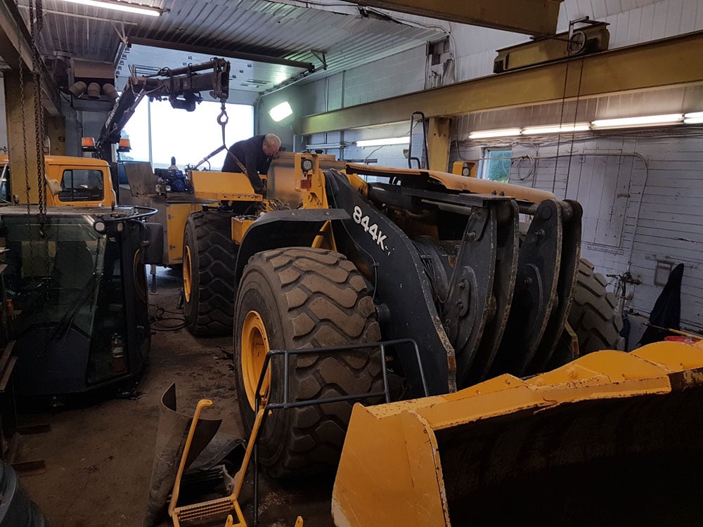 man working on CAT 844K Wheel Dozer